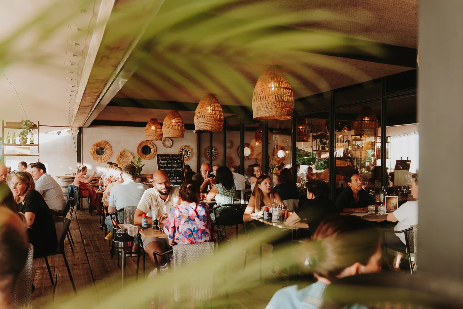 Volle zaal onder de rieten lampen van Toma Maté